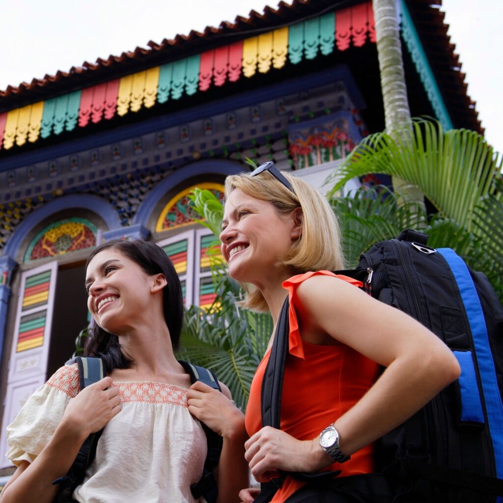 two girls with backpacks smiling